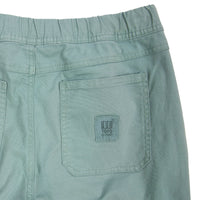 General back detail shot of Topo Designs Women's Dirt Pants in Sage green showing back pocket and logo patch.