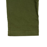 General detail shot of Topo Designs Men's Dirt Pants in Olive green showing bottom hem on leg.