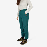 Close-up 3/4 front model shot of Topo Designs Women's Lightweight Tech Pants in "Juniper" green.