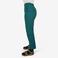 Close-up side model shot of Topo Designs Women's Lightweight Tech Pants in "Juniper" green.