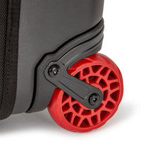 General shot of durable red wheels on Topo Designs Global Travel Bag Roller durable carry-on convertible laptop backpack rolling suitcase.