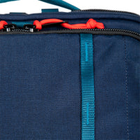 General shot of zipper pull tabs & daisy chain on Topo Designs Global Travel Bag Roller durable carry-on convertible laptop rolling backpack suitcase in Navy blue.