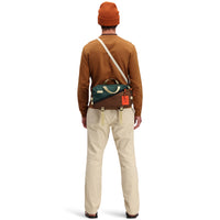 Back model shot of Topo Designs Men's Dirt Pants 100% organic cotton drawstring waist in "Sand" white