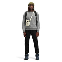 Model wearing Topo Designs Men's Global pullover Sweater recycled washable Italian wool in "Gray"
