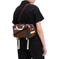 Back model shot of Topo Designs Women's Dirt Coverall 100% organic cotton short sleeve jumpsuit in "black"