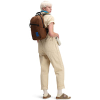 Back model shot of Topo Designs Women's Dirt Coverall 100% organic cotton short sleeve jumpsuit in "sand" white