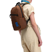 Back model shot of Topo Designs Women's Dirt Coverall 100% organic cotton short sleeve jumpsuit in "sand" white