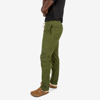 Close-up side model shot of Topo Designs Men's Dirt Shirt & Pants in "Olive" green.