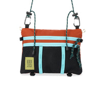 Topo Designs Mountain Accessory crossbody Shoulder Bag in orange "Clay / Black" lightweight recycled nylon.