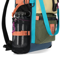 General shot of nalgene in expandable mesh side water bottle pockets on Topo Designs River Bag cinch top tote backpack with mesh sides in hemp brown olive green recycled nylon.
