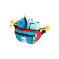 Open main compartment view of Topo Designs Mountain Waist Pack in lightweight recycled "Red / Turquoise" nylon.