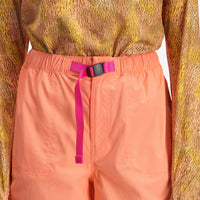 Front of short, close up shot of Topo Designs Women's River quick-dry swim Shorts in "Peach" on model.